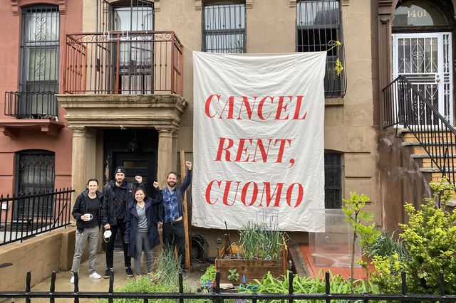 A "Cancel Rent, Cuomo" sign held up by New Yorkers